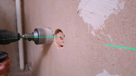 Drilling Operator Widens Wall Opening Guided By Laser Line Visibility 库存影片 329107289