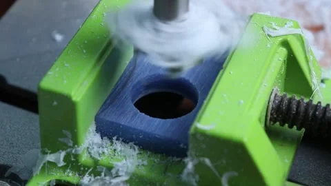 Drilling a piece of blue epoxy resin with a drill Stock Footage 225524749