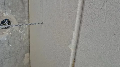 Drilling a pilot hole in the wall for air conditioner pre-installation Stock Footage 338020289