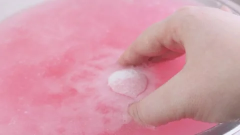 Drilling pink fluid. Foam and bubbles when dissolving a salt cosmetic bomb. Stock Footage 234070732