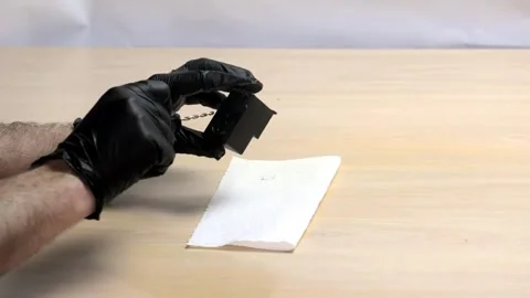 Drilling Precision: Creating a Clean Hole in Black Cartridge Stock Footage 319628868