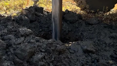 Drilling process in a construction site using a brown drilling rig Stock Footage 346895308