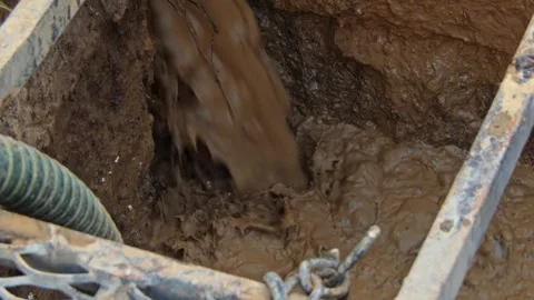 Drilling process for water well in rural setting with mud and debris Stock Footage 336792792