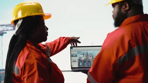 Drilling rig boat engineering team using laptop to monitor equipment systems Stock Footage 319970484