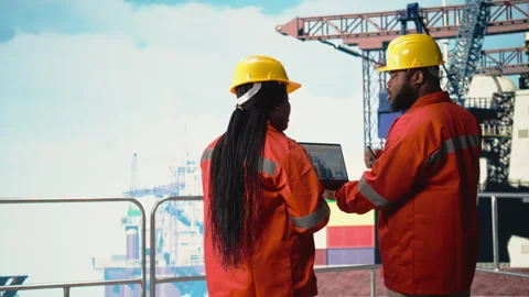 Drilling rig boat engineering team using laptop to monitor equipment systems Stock Footage 319974582