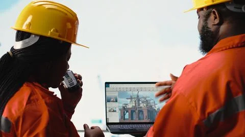 Drilling rig boat engineering team using laptop to monitor equipment systems Stock Photos