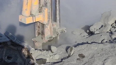 The drilling rig does its job, drills a hole in rock, in a quarry. Stock Footage 124916694