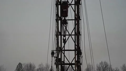 Drilling rig. Drill rotates Top drive goes down. Metal tower. Yellow supports Stock Footage 151352527