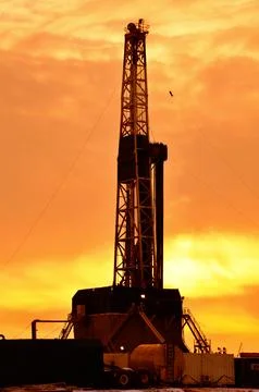The drilling rig during sunset Stock Photos