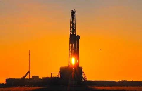 The drilling rig during sunset Stock Photos
