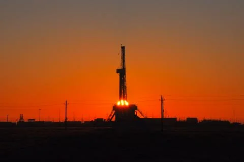 The drilling rig during sunset Stock Photos