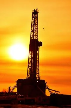 The drilling rig during sunset Stock Photos