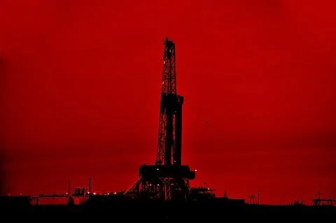 The drilling rig during sunset Stock Photos