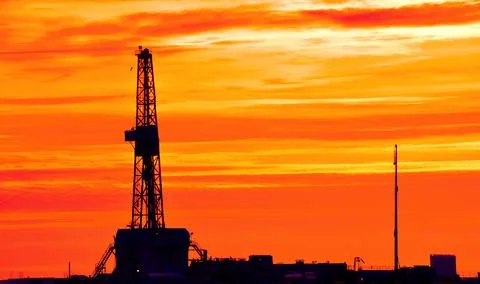 The drilling rig during sunset Stock Photos