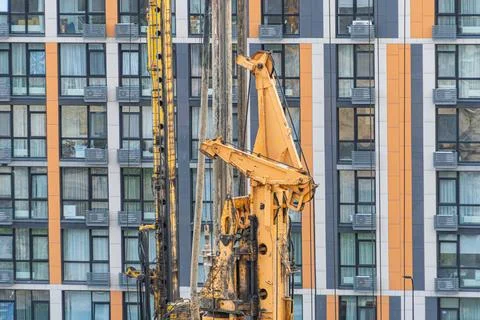 Drilling rig engaged in construction task, vibrant colors contrast against .. Stock Photos