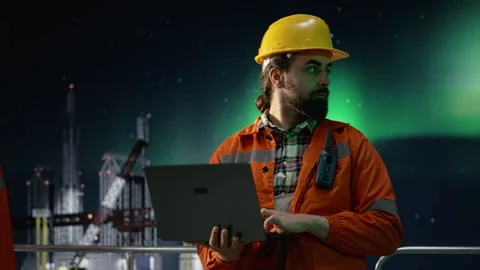 Drilling rig engineer analyzing oil crisis logistics with laptop Stock Footage 336198814