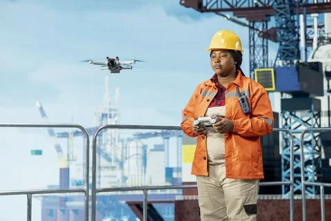 Drilling rig expert flying drone for quick overview and evaluation Stock Photos