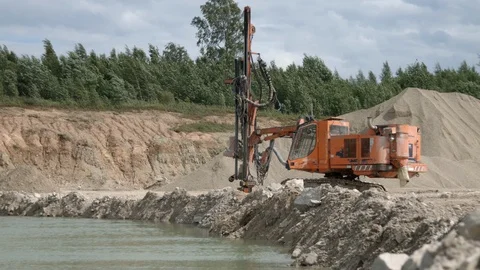 Drilling rig making blast holes into the rock in open-pit mining quarry Stock Footage 123056476