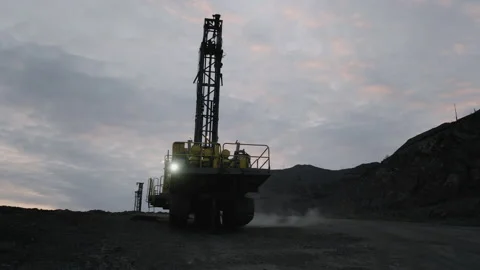 A drilling rig operates in the open pit in the evening Stock Footage 168651607