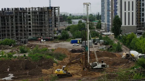 Drilling rig performing foundation work at large residential construction sit Stock Footage 311641960