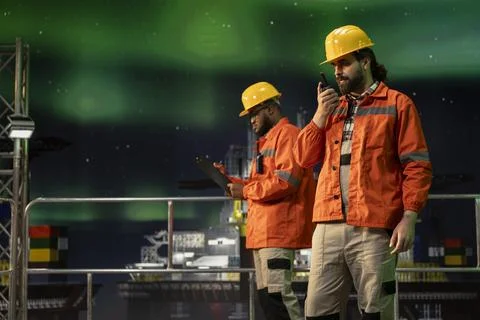 Drilling rig radio operators using walkie talkie to coordinate procedures Stock Photos