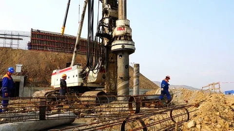 The drilling rig scrolls the auger with casing in the ground for construction Video stock 74006365