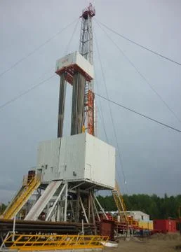 Drilling rig on a summer evening. Oil production. Stock Photos