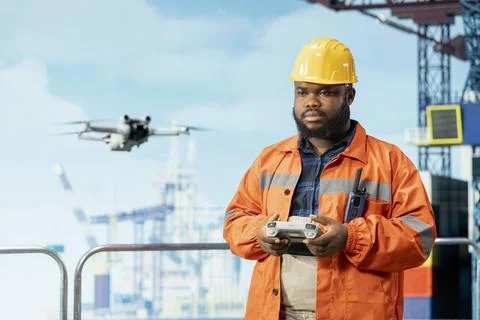 Drilling rig technician using drone gadget for quick overview and evaluation Stock Photos