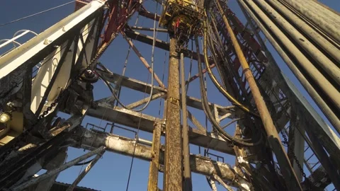 Drilling rig. Top drive goes down with pipe. Assembling tube layout. View up Stock Footage 224047836