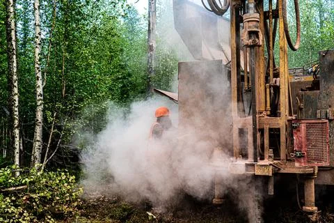 Drilling rig while drilling a well. A lot of dust during geological drilling Stock Photos
