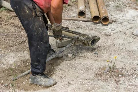 Drilling rig worker with monkey wrench install PDC core bit Stock Photos