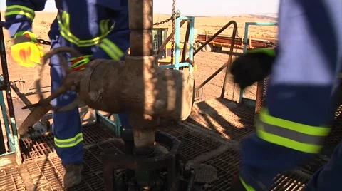 Drilling Rig workers installing a valve Stock-Footage 40366742