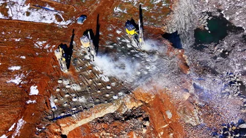 Drilling rigs working on rock surface in open pit mine Stock Footage 333839235