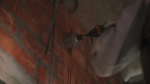 Drilling a round hole in the wall Stock Footage 284155704