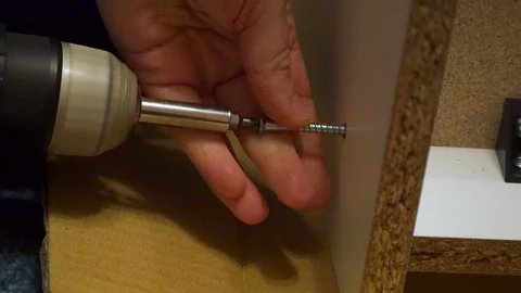 Drilling a screw into a flatpack cupboard Stock Footage 122205998