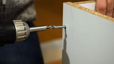 Drilling a screw into a flatpack cupboard 動画素材 122206224