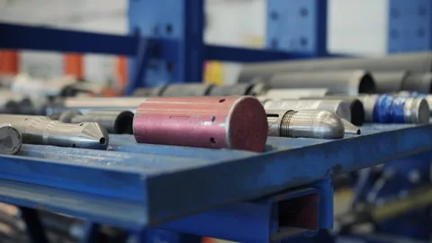 Drilling tool components stored on metal rack in warehouse Stock Footage 309327881