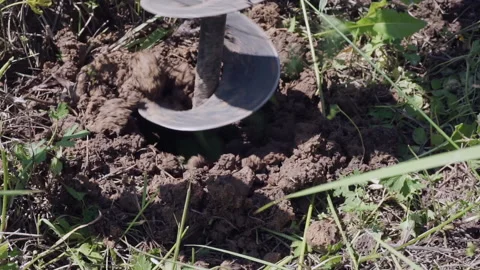A drilling tool drills a hole in the ground Stock Footage 156543443