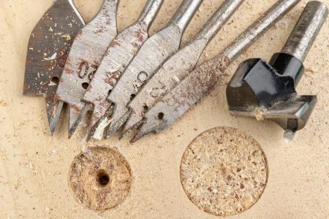 Drilling with a vane drill in chipboard. Carpentry work in a carpentry worksh Stock Photos