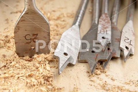 Drilling with a vane drill in chipboard. Carpentry work in a carpentry worksh Stock Photos