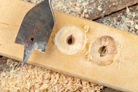 Drilling with a vane drill in chipboard. Carpentry work in a carpentry worksh Stock Photos