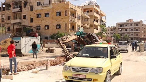Drilling Vehicle Falls into a Pit in Aleppo as Syrians Struggle to Rescue It Stock Footage 295041342