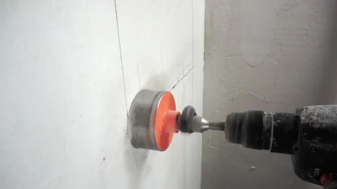 Drilling the wall to install the outlet. Stock Footage 273351090