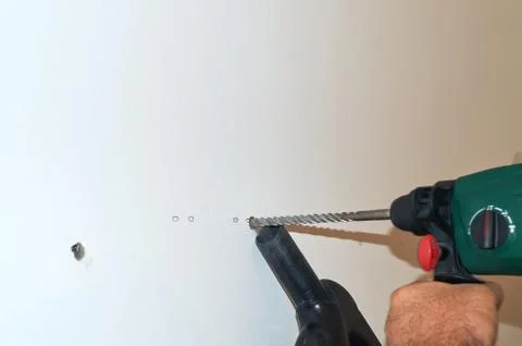 Drilling a wall Stock Photos