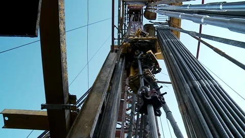 Drilling of the well.  Looking upwards inside the derrick. Stock Footage 255598348