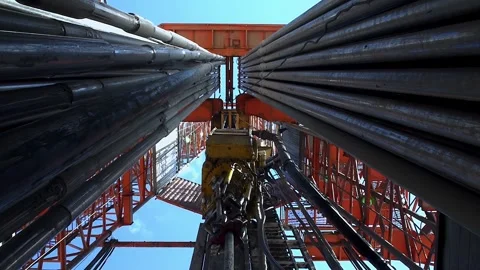 Drilling of the well.  Looking upwards inside the drilling rig. Stock Footage 255977991
