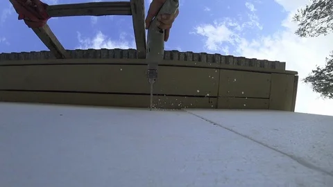 Drills a drill wall. Styrofoam. Warming of the wall. Finishing the house. Stock Footage 94071128