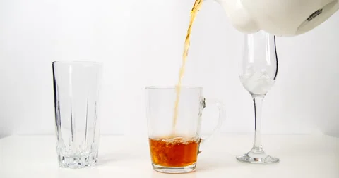 Drink black tea in a transparent cup and teapot Stock Footage 143122202