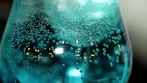 Drink blue lagoon close-up bubbles. Bubbles rise up the glass. Stock Footage 135689275