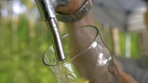 The drink bubbles and foams. Close-up of the hands. Stock Footage 235485531